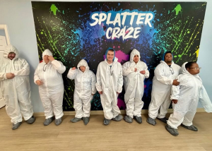 Adult Program clients enjoying a creative painting session at Splatter Craze, exploring color, self-expression and hands-on art.